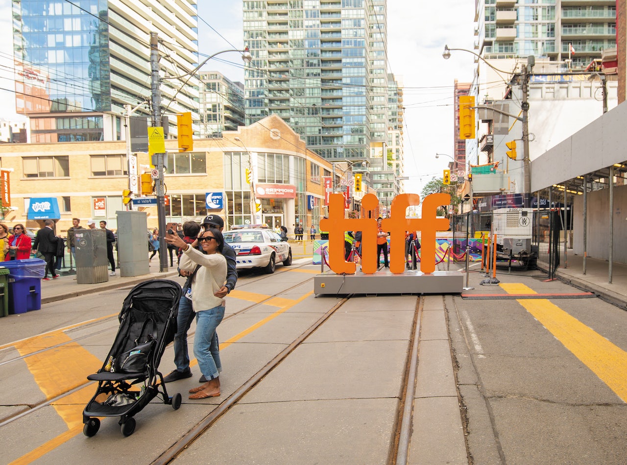 a couple taking a selfie at the Tiff sign