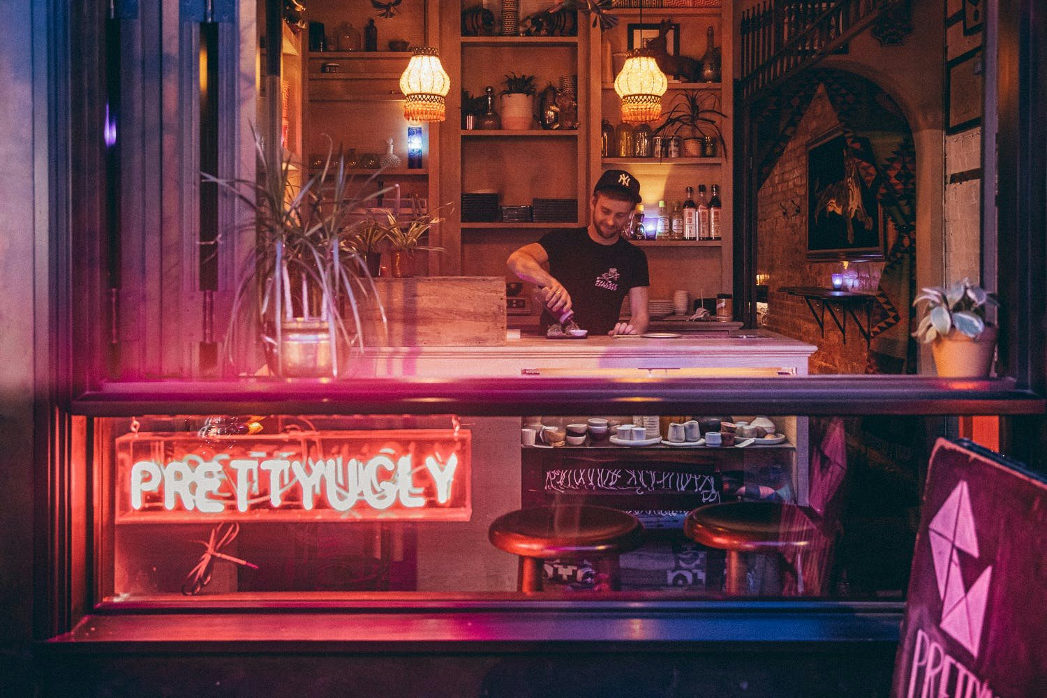 bartender serving a cocktail at Pretty Ugly Bar