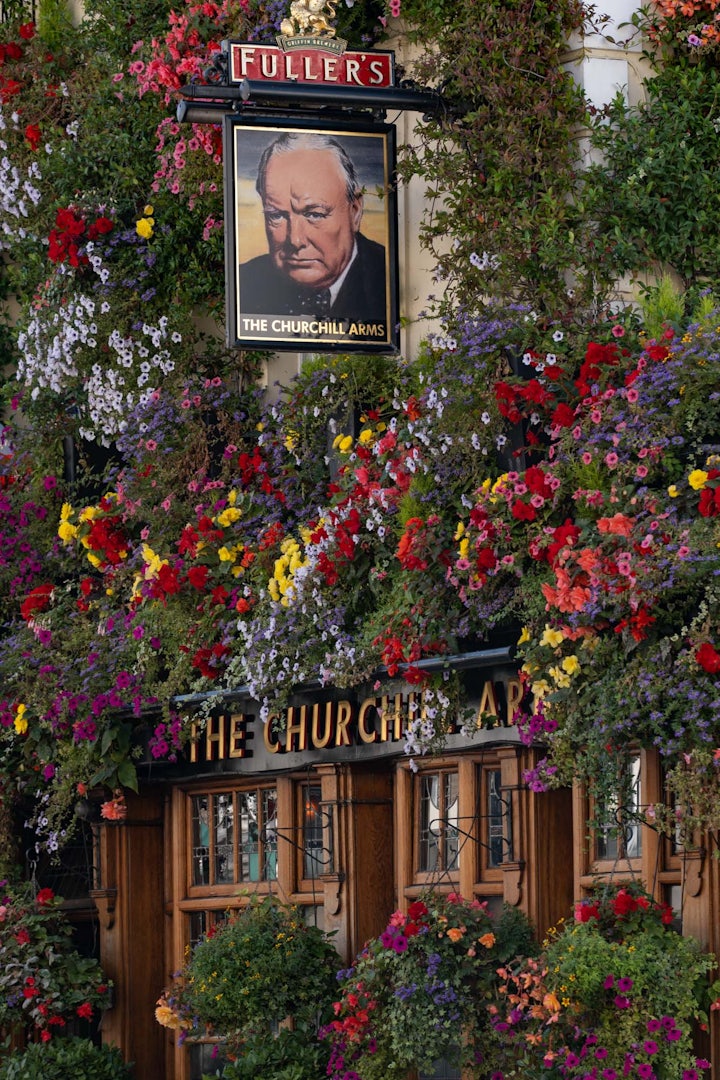 exterior of The Churchill Arms pub full of flowers