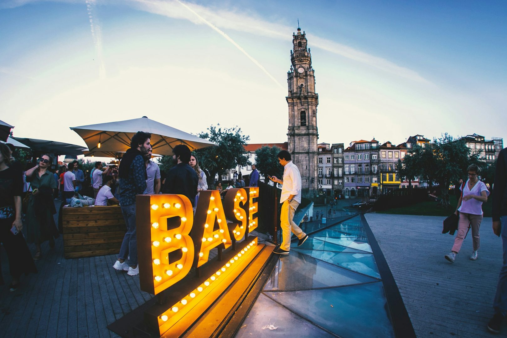 people on the terrace of Base bar in Porto with view of a tower