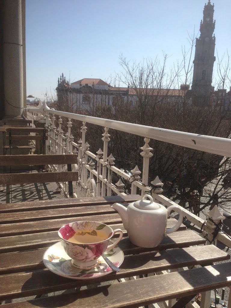 a table with a cup of tea on the balcony of Era Uma Vez in Porto