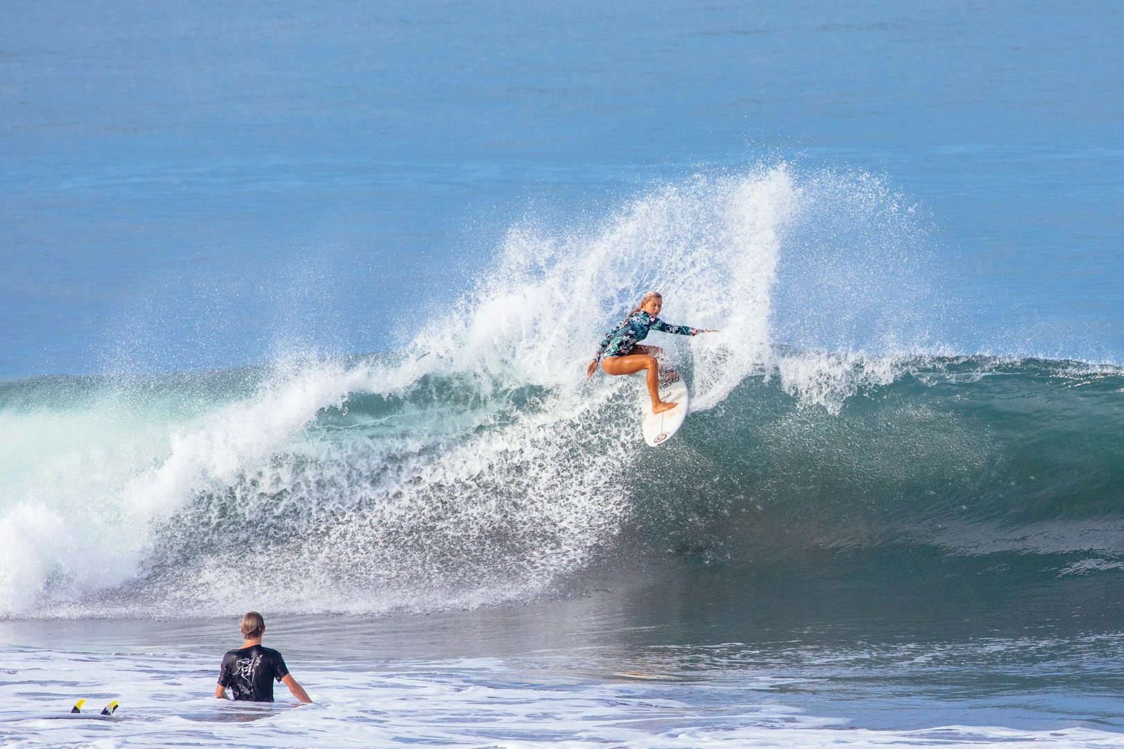 a woman surfing a shortboard on high level