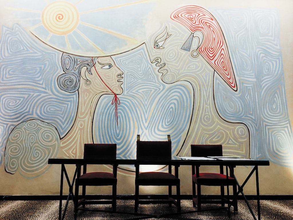 a painting on the wall of a couple by Jean Cocteau at the Hotel de Ville Menton