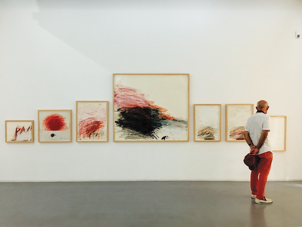 a man dressed in red pants is admiring art at the Collection Lambert