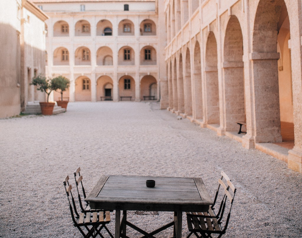 a table with chairs at the inner court of Le Charité Café