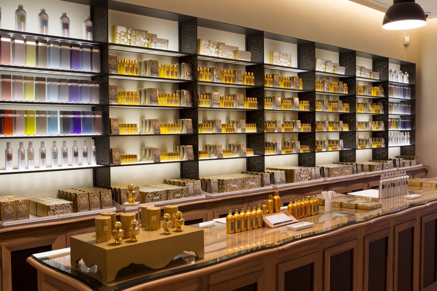 shop interior with a wall full of perfume bottles at Perfumerie Fregonard