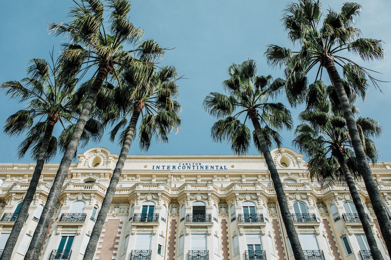 building facade and palmtrees at the Carlton Hotel in Cannes