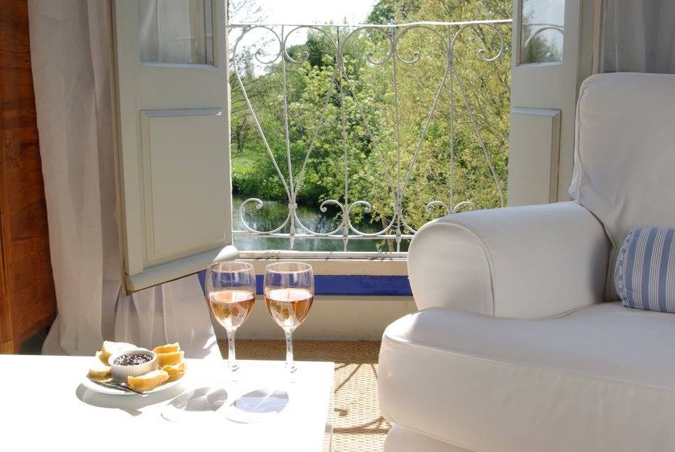 table with some snack and rose wine in a room at  La Bastide Rose hotel 