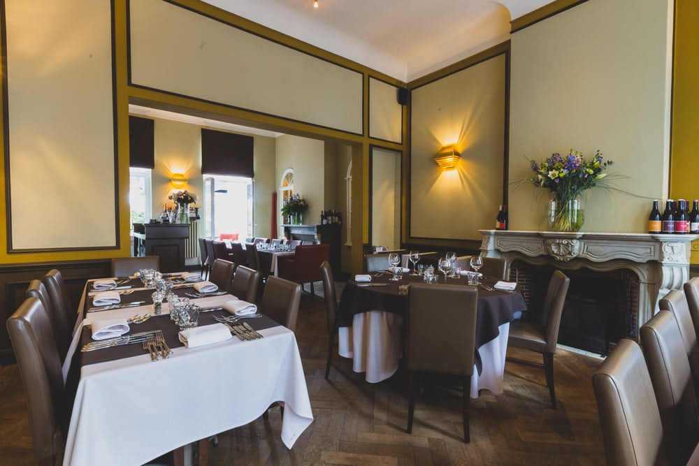 restaurant interior and set tables at Faim Fatale Ghent