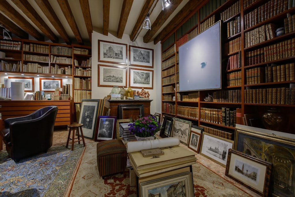 interior of Libreria Linea d’Acqua filled with old books and antique 