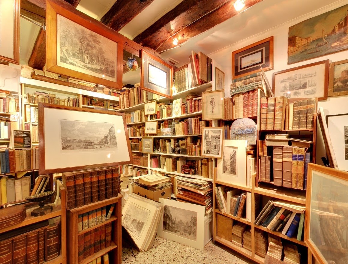 interior of book store filled with antique books at Libreria Segni Nel Tempo