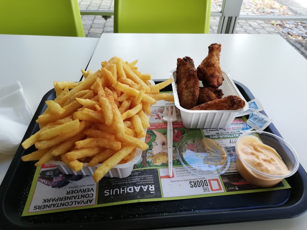 a plate of delicious fries and chicken wings from Frituur Bosrand