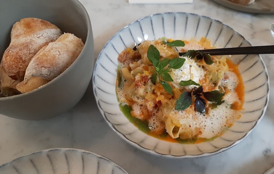 a plate of pasta and bread on the side at nr 12 by Helsen restaurant