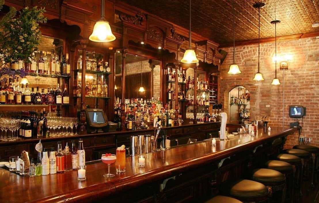 vintage and warm bar interior of Clover Club