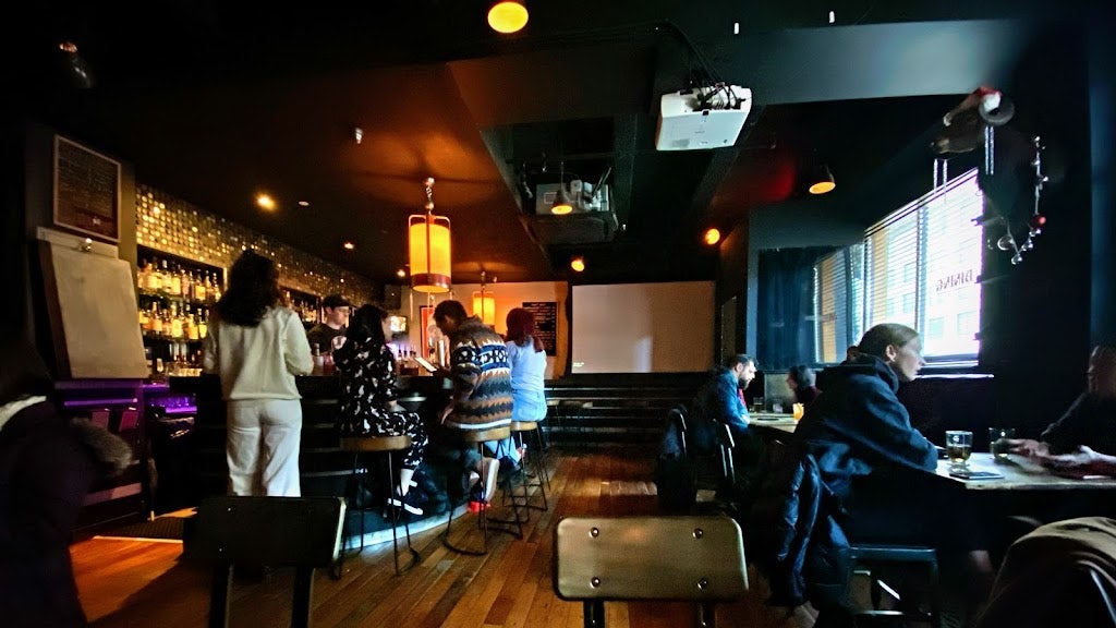 people enjoying drinks in Nitehawk Cinema