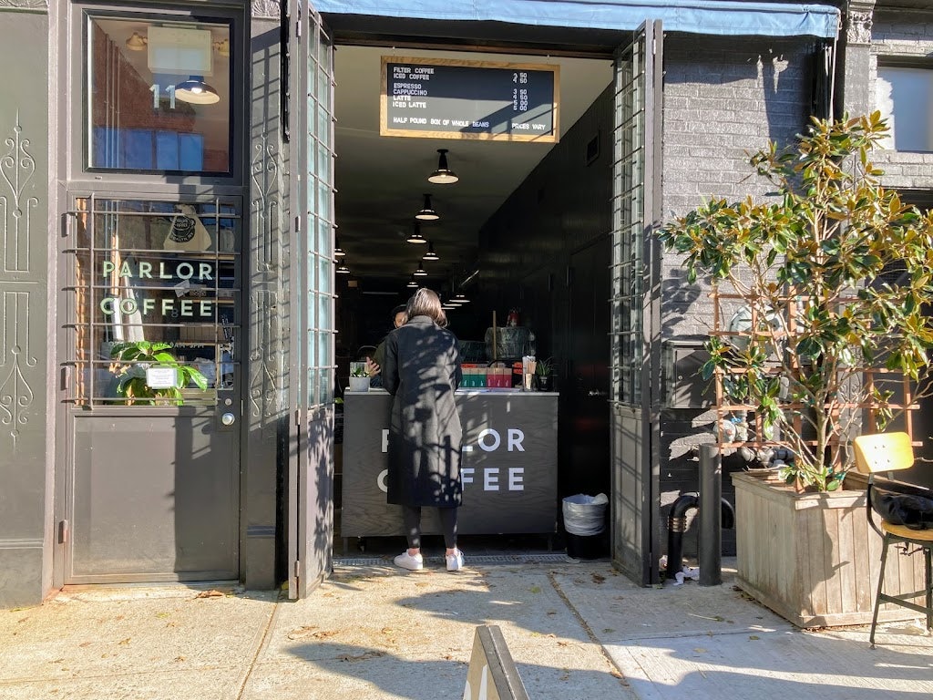 a woman ordering coffee to take out at Parlor Coffee