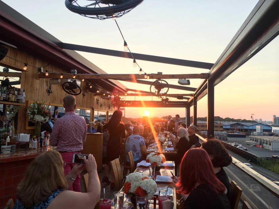 people eating and enjoying the sunset view from Alma restaurant