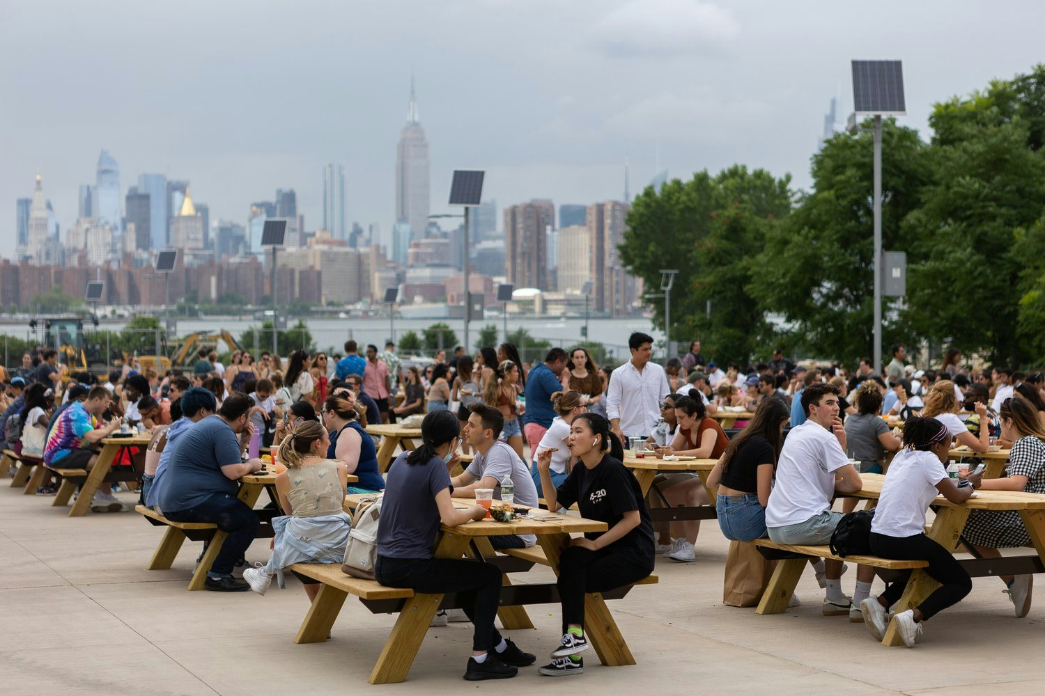 people enjoying food and drinks at Smorgasburg market in Brooklyn