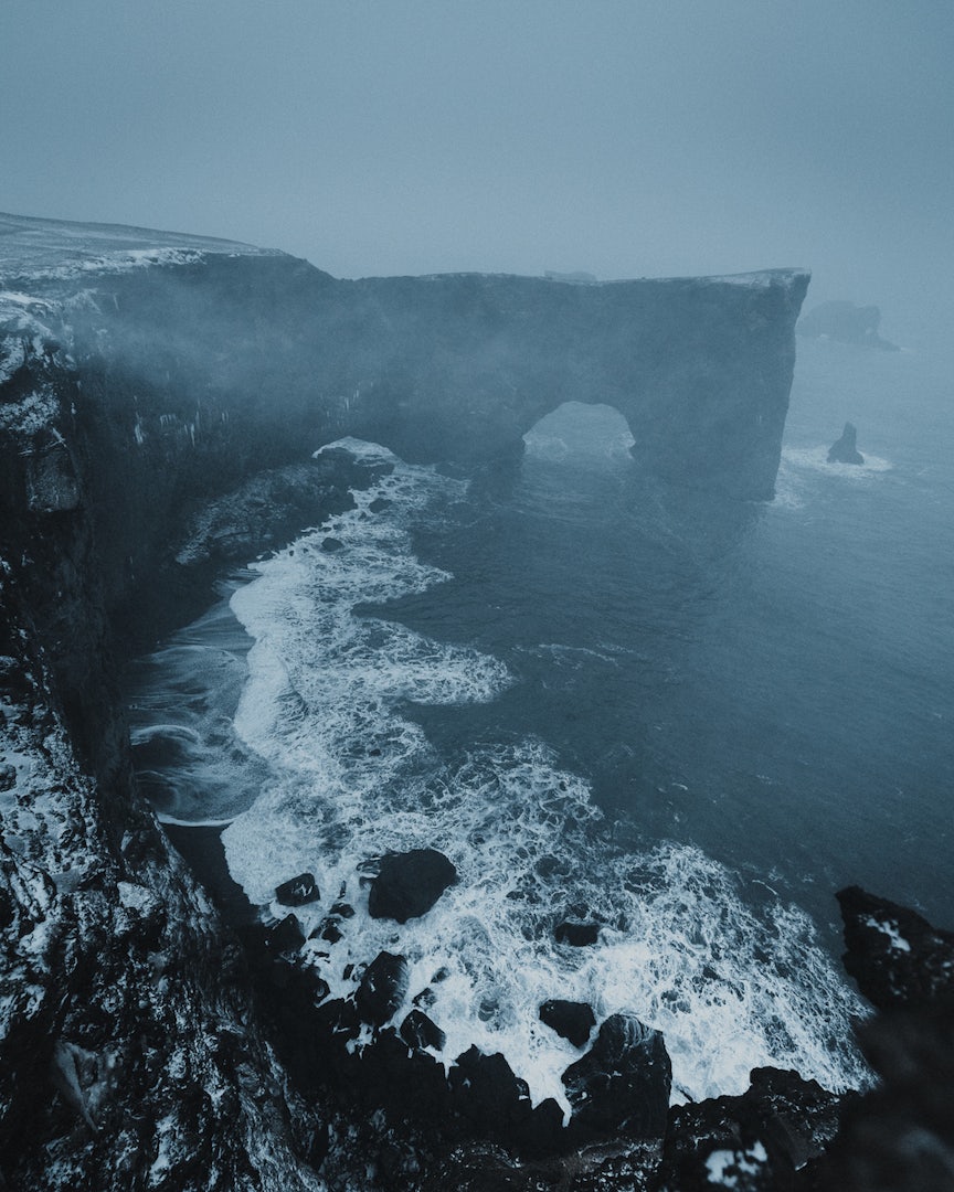 a foggy view over the Dyrhólaey Rock Arch