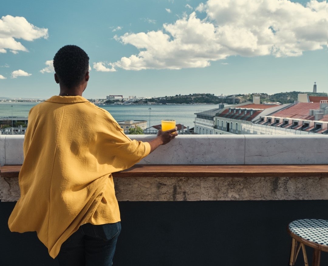 a woman enjoying the view over Lisbon at Java rooftop bar