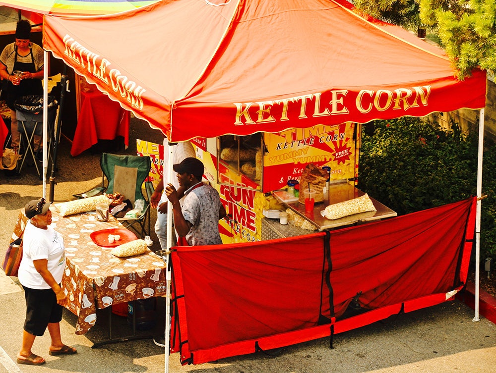 Top view of a red kettle corn stall at the Crenshaw Farmers Market in Los Angeles