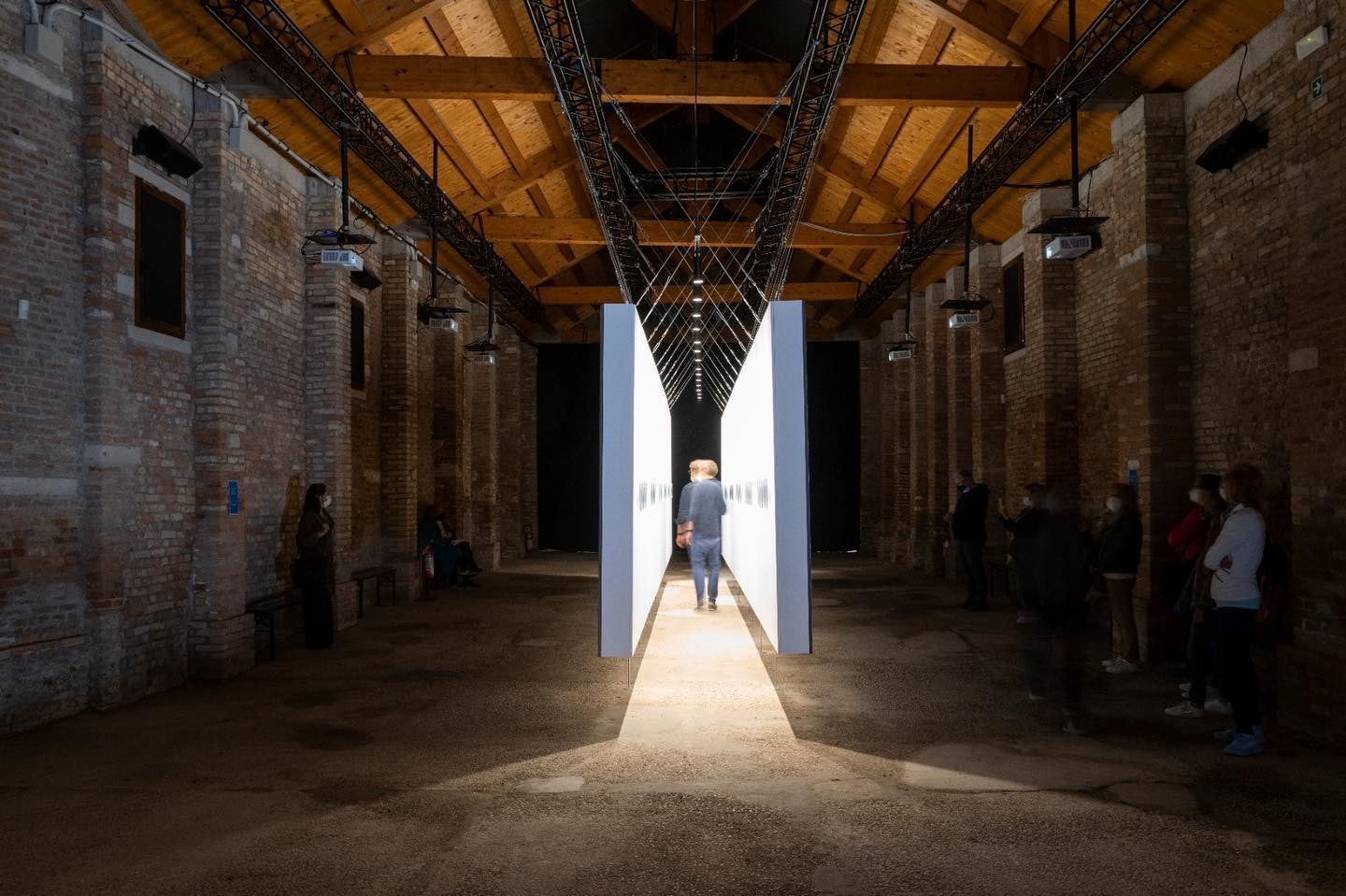 Man walking through a lighted art installation at Catalonia in Venice