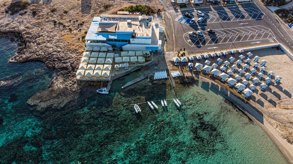 drone shot over Tortuga beach club and azure blue waters