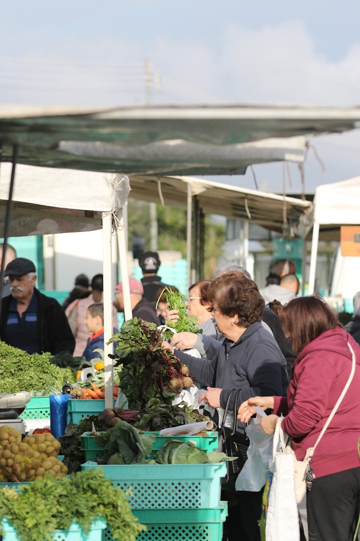 a woman shopping groceries at the Farmer's Market in Ta' Qali