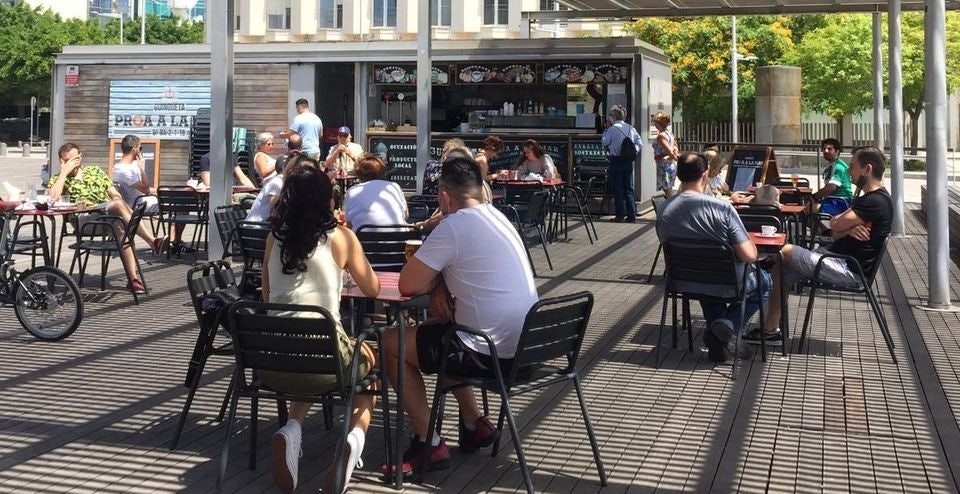 People sitting on the terrace of Guingueta Proa a la Mar