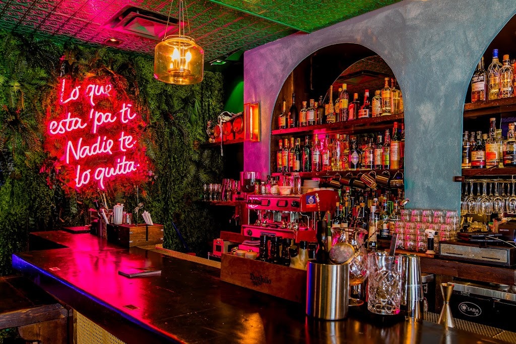 colourful restaurant interior and neon-lit bar at Calle 23 Miami 