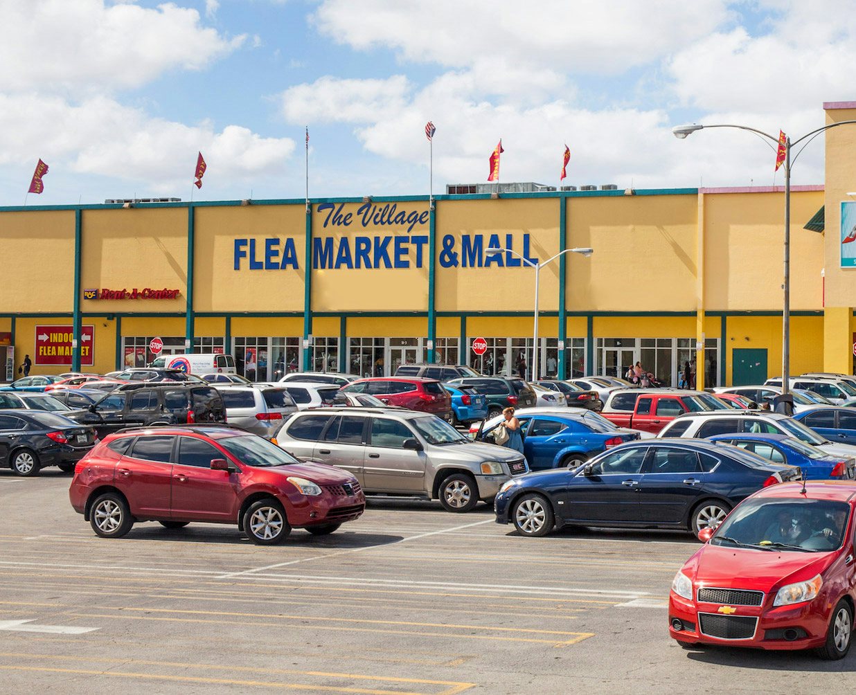 yellow exterior of The Village Flea Market and Mall in Miami