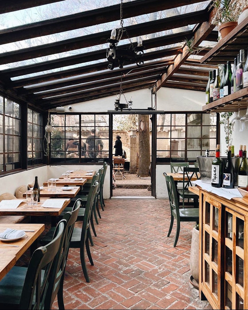 Interior and greenhouse of Colonia Verde Restaurant in Brooklyn