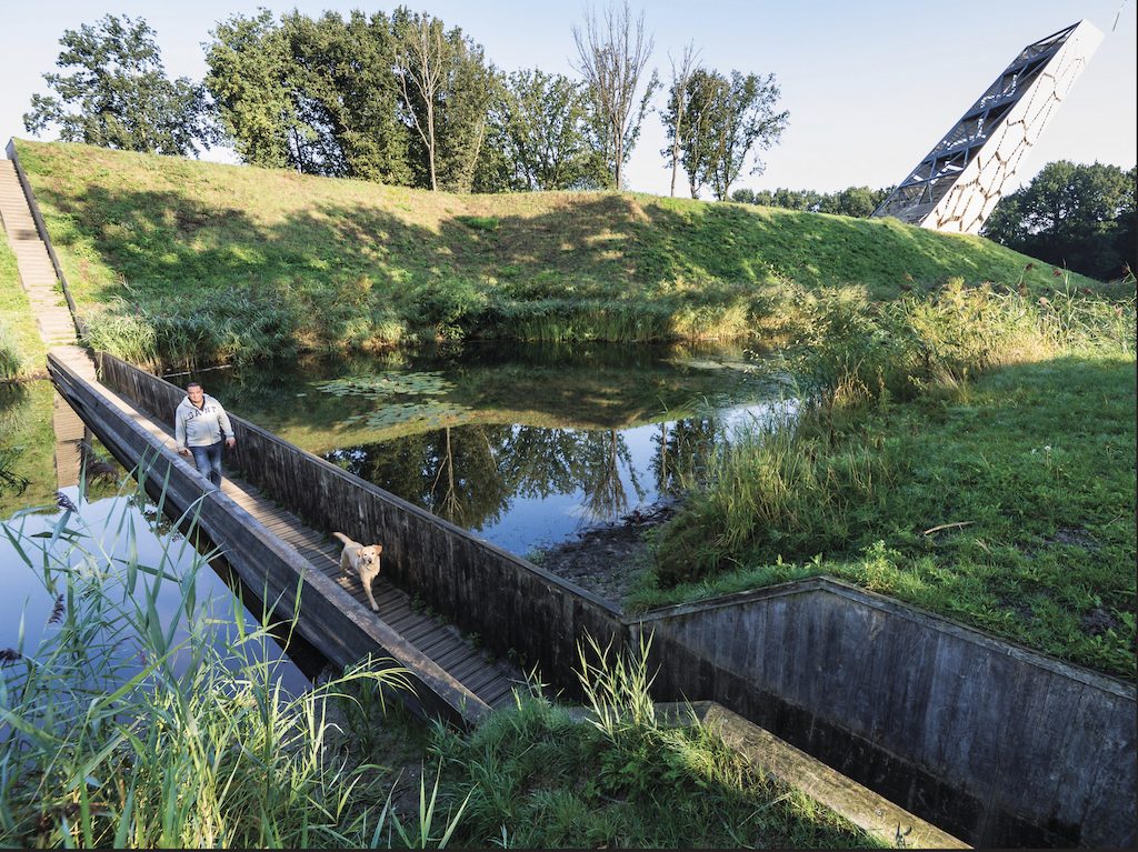 a man walking his dog over the Mozesbrug