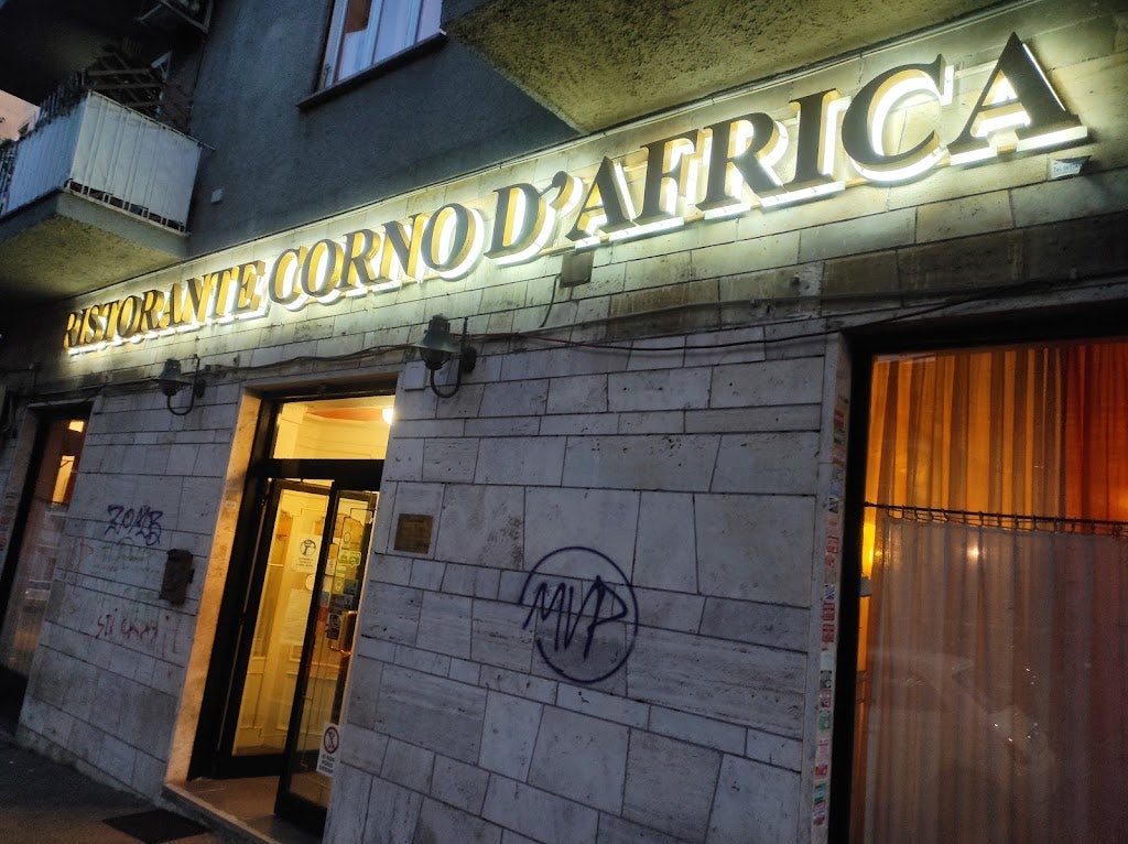 restaurant facade and sign at night of Corno d'Africa in Rome