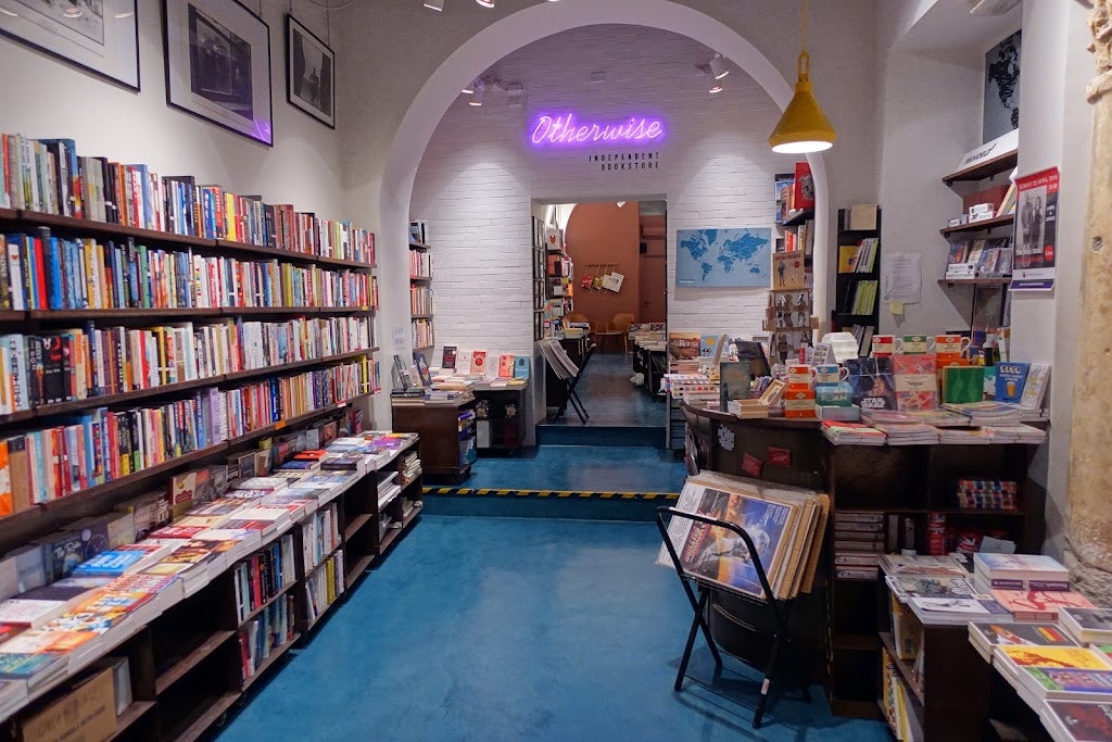 books stacked inside of Otherwise Bookshop Rome