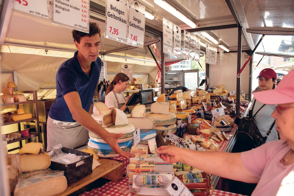 a man serving cheese at the centremarkt Rotterdam