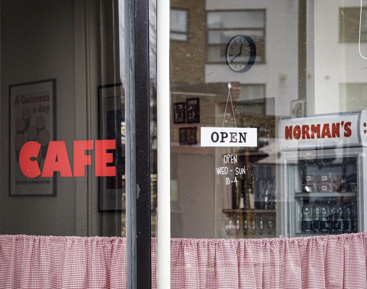 Window and opening hours at Norman's Cafe