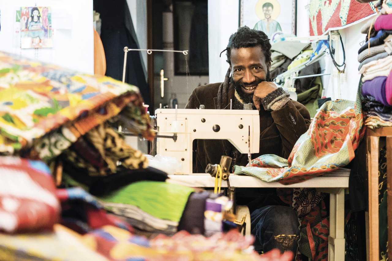 owner of Métissage atelier in Roma amidst African wax fabric