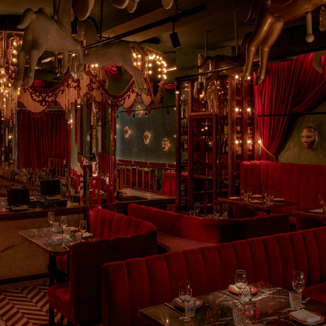 Red plush circus-style interior at restaurant Arrogante in Madrid