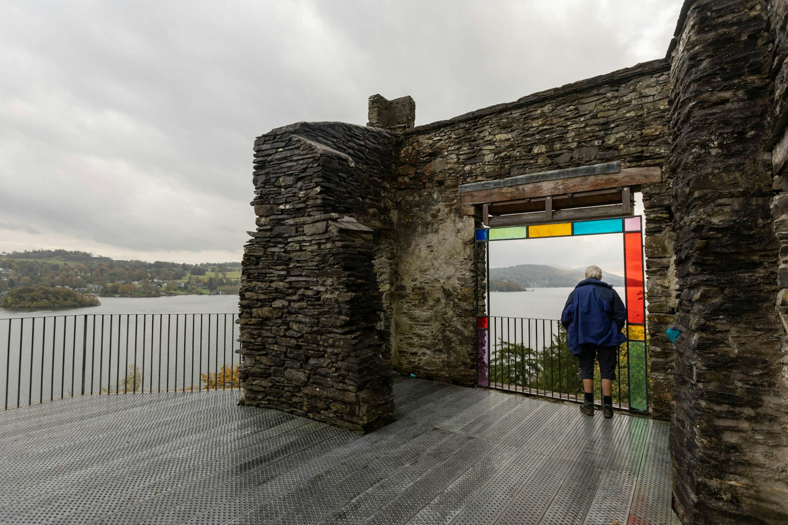 A person looks out over the water from Claife Viewing Station