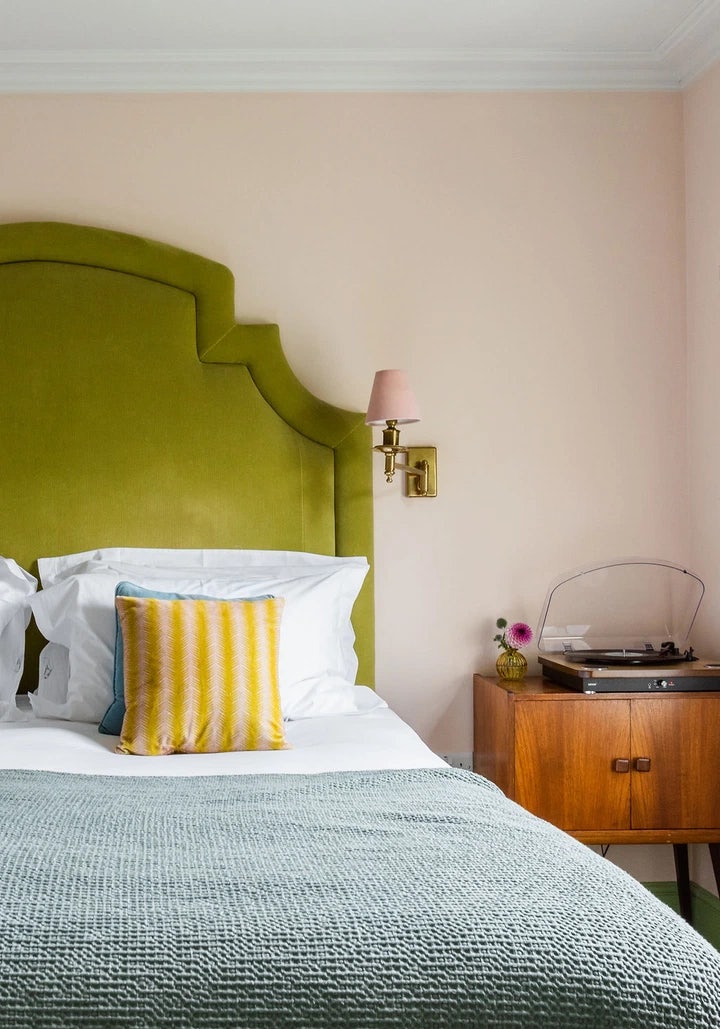 A bed and sidetable in a room at The Rose