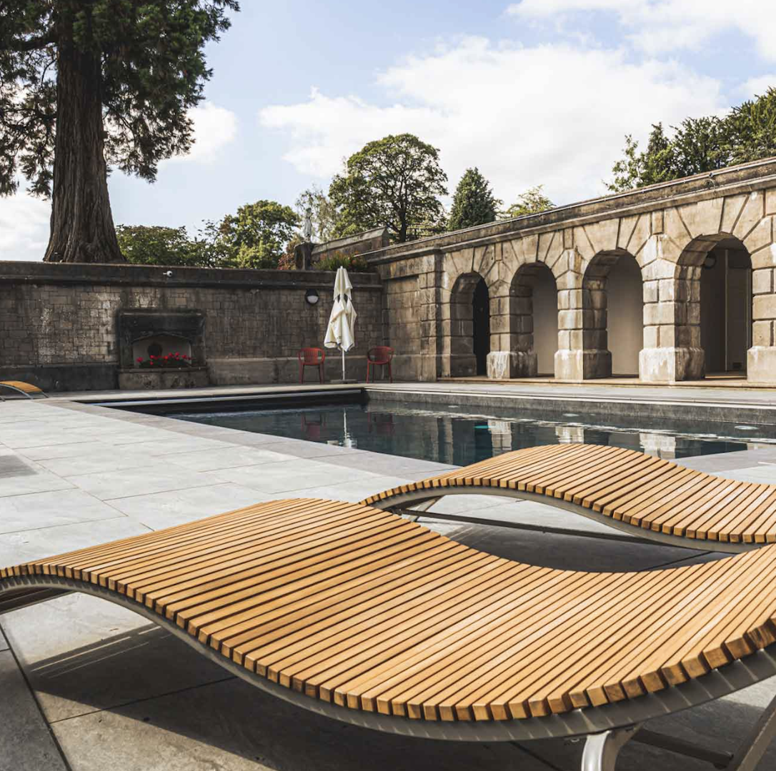 Outdoor pool with lounge chairs at The Tawny Consall