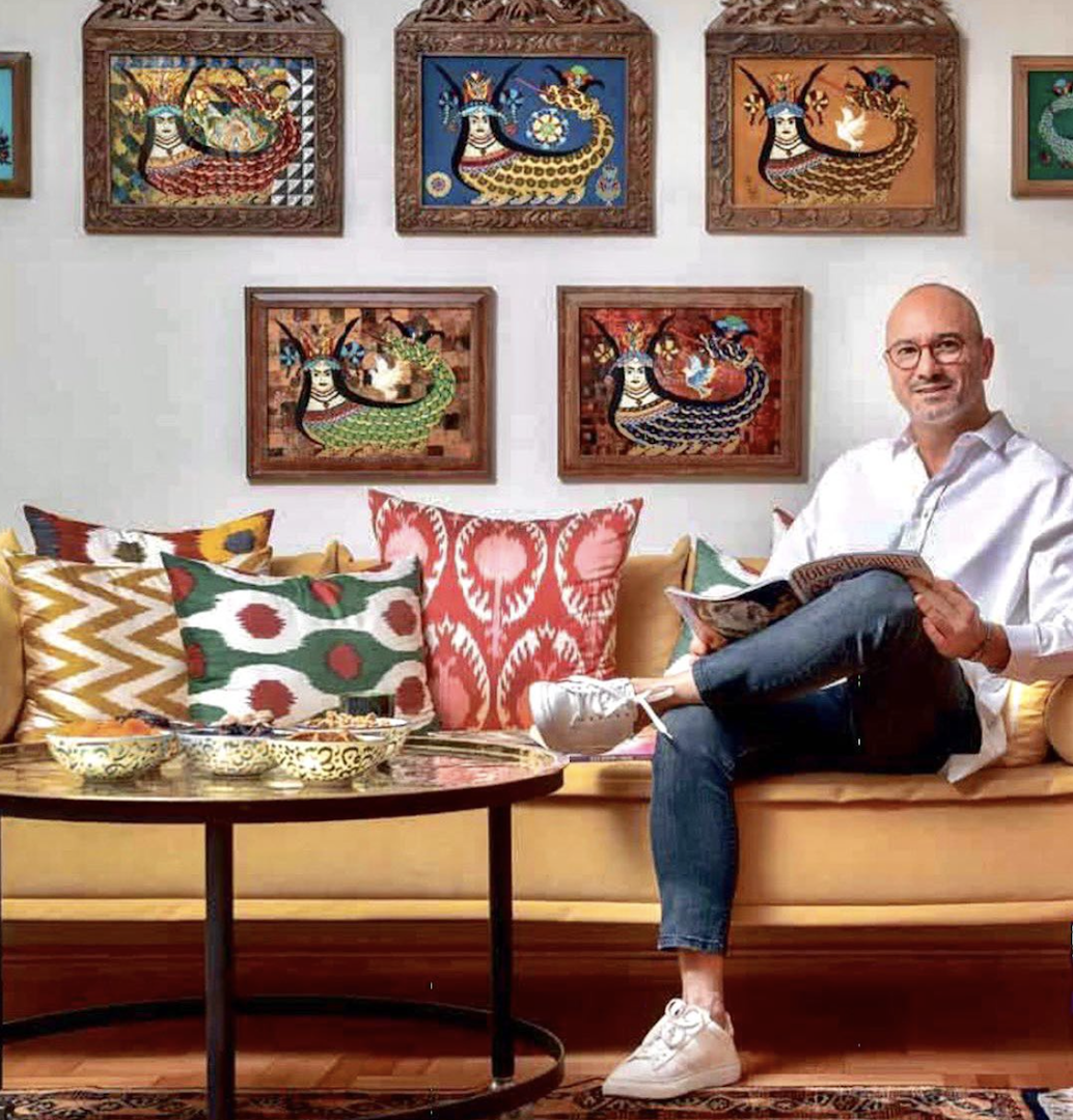 Home décor shop of Omar Baban, sitting on a sofa with colourful pillows