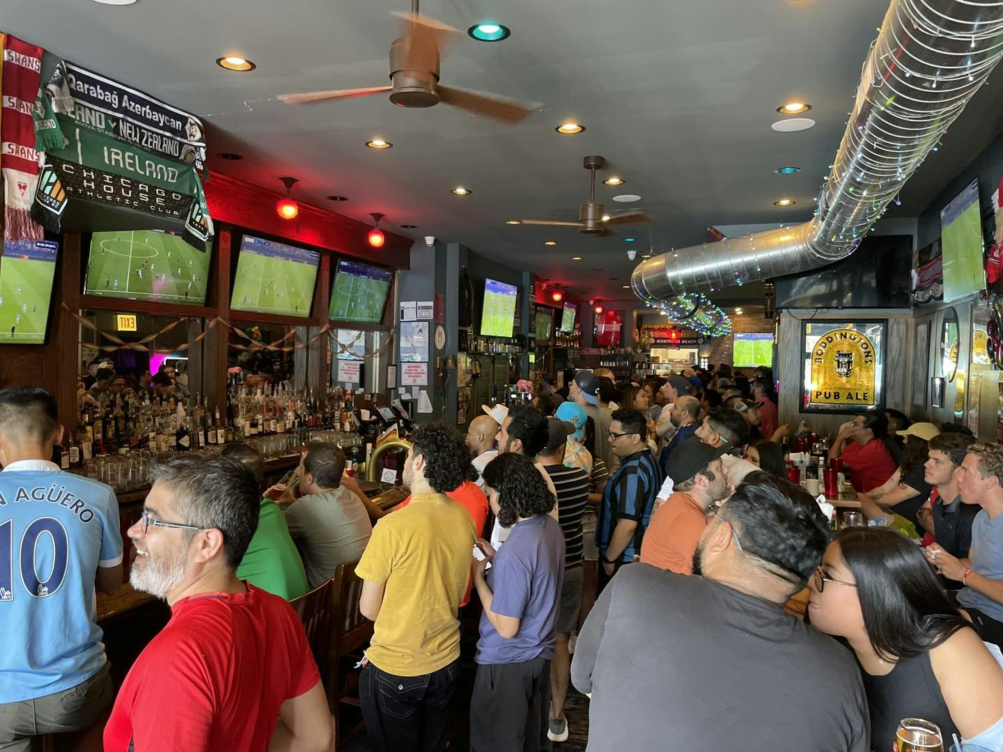 a crowd enjoying a soccer game in The Globe Pub