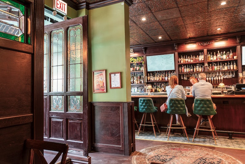 a couple seated at the bar of The Green Post Chicago