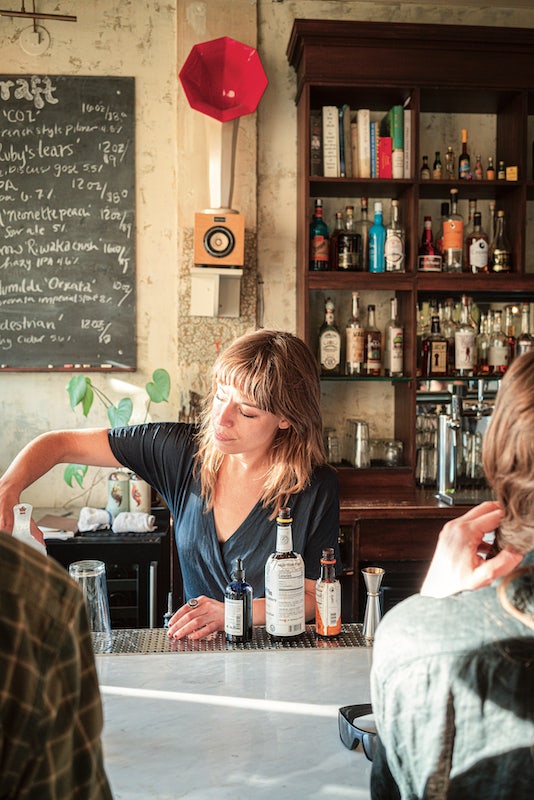 bar tender pouring a drink at Lula Cafe in Chicago