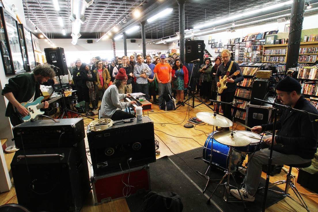 a band performing inside of Reckless Records shop