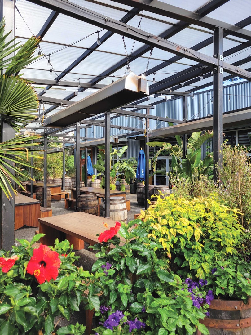 Outdoor covered patio with flowers and plants at Fremont Brewery