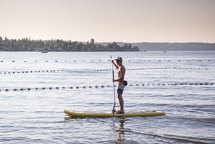 a man doing stand up paddling at Lake Sammamish