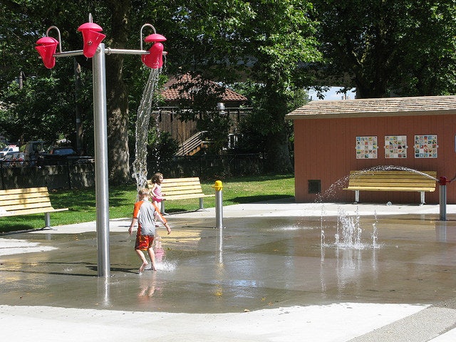 a little boy playing in the spray park at Georgetown Playfield